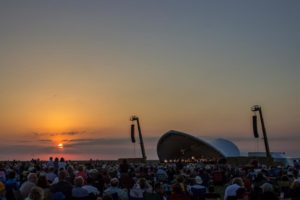The sun sets as the Kansas City Symphony begins to play at the 9th Symphony in the Flint Hills in Rosalia, Kan. at Rosalia Ranch on June 14. Photo by Kevin Brown.